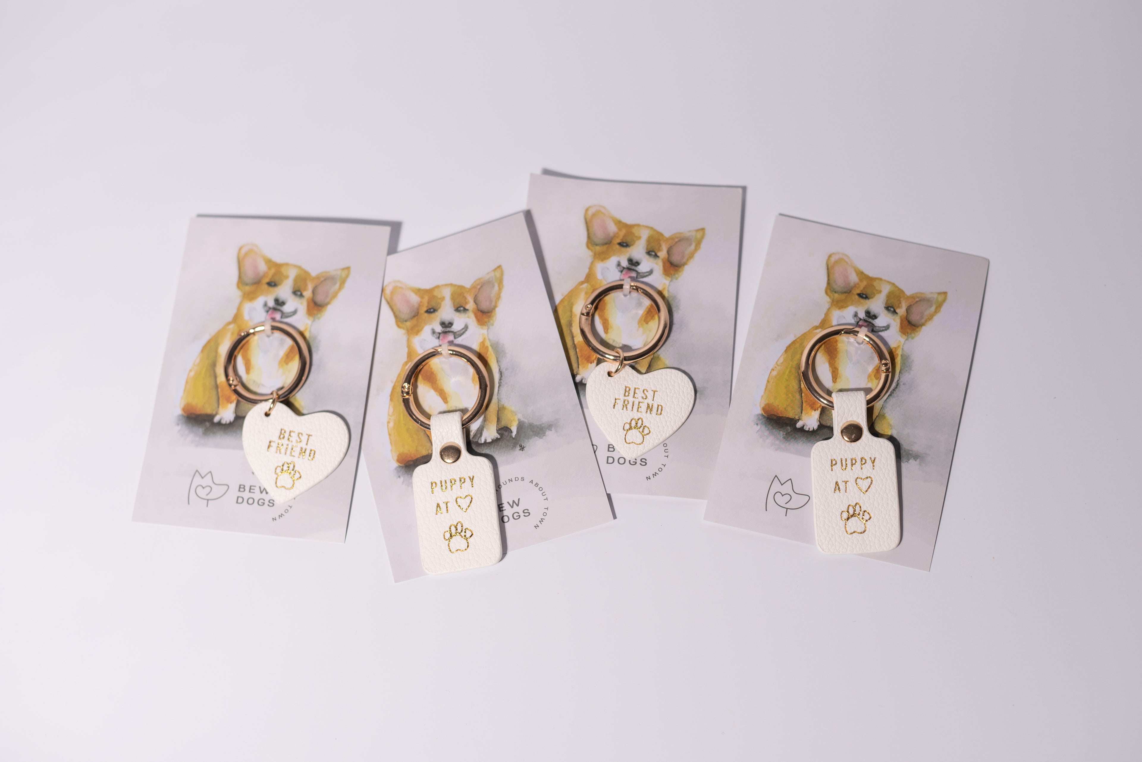 4 cute collar tags, saying "best friend" or "puppy at heart" connected to card, are shown against a grey background