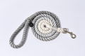 A grey and white, ombre rope lead for dogs with thick braided rope, and silver hardware - a strong & stylish lead for dogs of all sizes, set against a plain studio background 