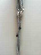 Gray and white rope dog lead with metal clasps on a light grey background, for stylish dogs