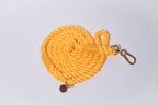 Yellow orange rope lead with a metal clip on a light grey background. Soft, strong and durable for all dogs. 