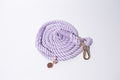 A gorgeous pastel lilac rope lead for dogs, with stunning gold detailing, set against a white studio background 