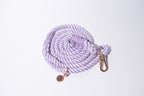 A gorgeous pastel lilac rope lead for dogs, with stunning gold detailing, set against a white studio background 