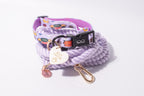 A dog collar and matching braided rope accessory set in lilac purple, featuring a black plastic buckle, a white heart-shaped tag that reads 'Best Friends', and rose gold-toned hardware, photographed on a clean white background.