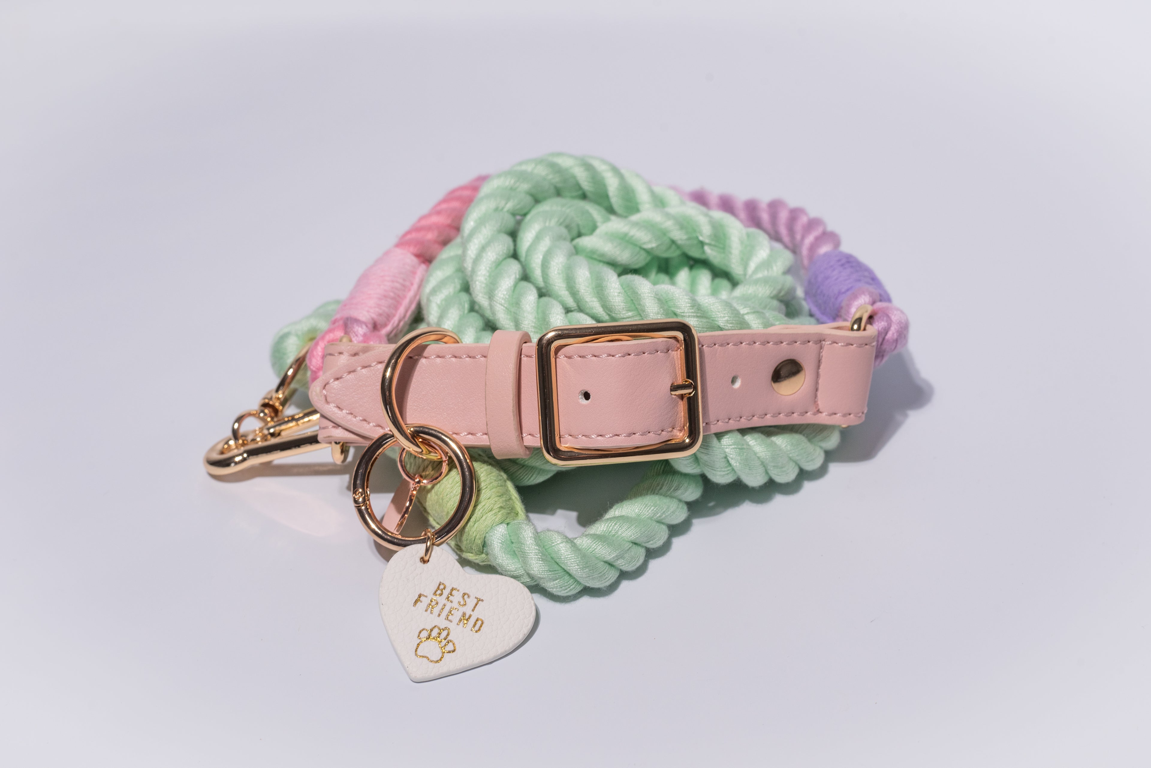 Dog collar with pastel-colored rope, pink leather strap, and 'Best Friend' tag on a light grey background - luxury accessories for dogs of all shapes and sizes