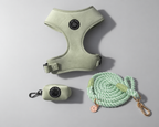 A dog walking harness set in pale sage green, including a green velvet harness, a small matching case to hold poo bags, and a thick mint green rope lead with gold-tone hardware, arranged on a light gray background - a sage green set for all dogs including size L & XL