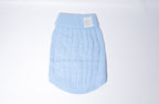 A light blue cable-knit dog sweater with a ribbed collar and a small white Bew Dogs brand patch on the front, shown against a plain white studio background, the ideal jumper for small
Dogs or puppies. 