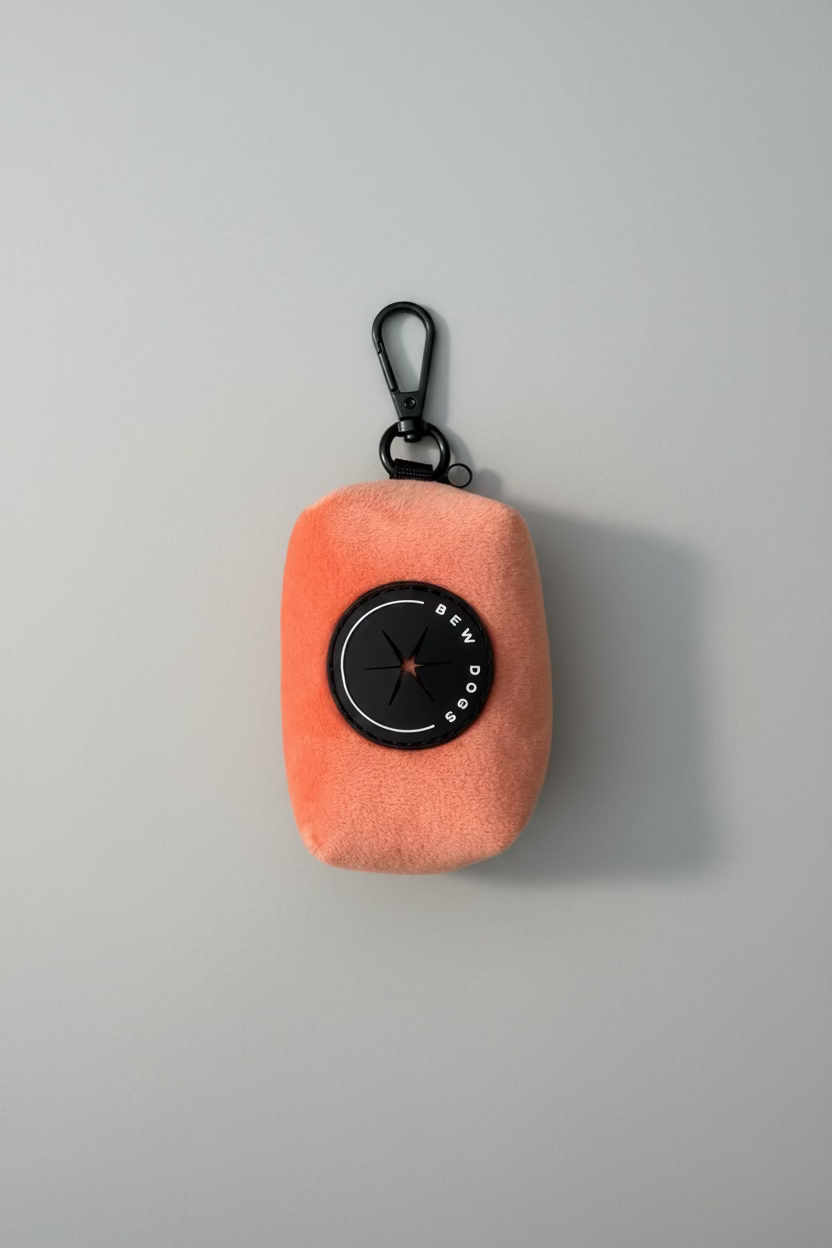 Peach velvet poo bag holder for dogs, studio shot against a grey background