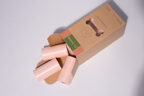 One box of Bew Dogs biodegrable and eco-friendly poo bags, peach in colour and displayed in front of a grey background