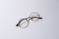 Round eyeglasses with gold frame, fun novelty item for cats and dogs, on a white background