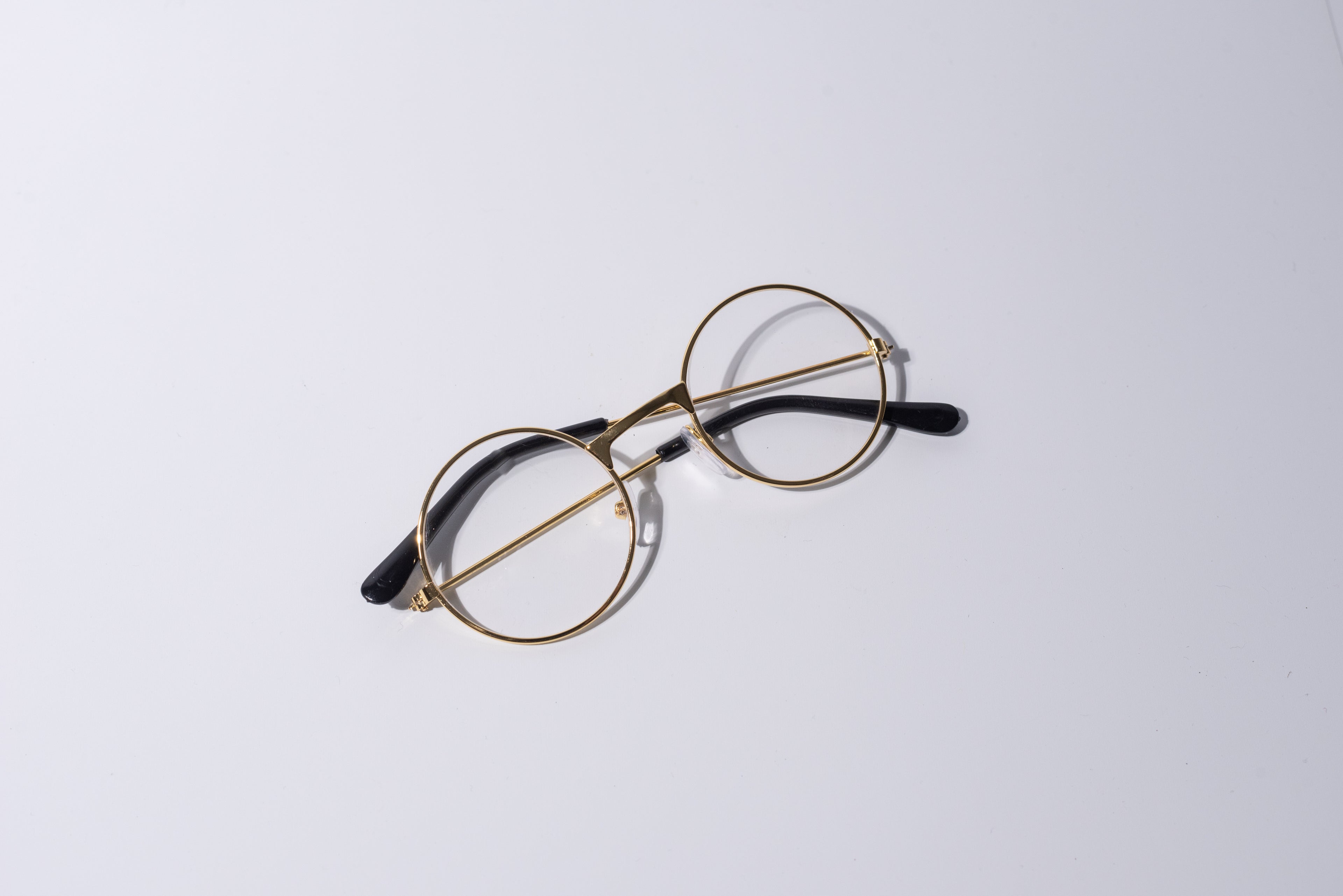 Round eyeglasses with gold frame, fun novelty item for cats and dogs, on a white background