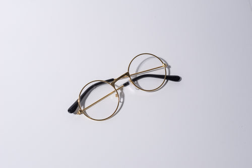 Round eyeglasses with gold frame, fun novelty item for cats and dogs, on a white background