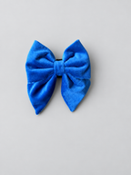 midnight blue velvet sailor bow for dogs, which connects to any collar - set against a grey studio background