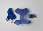 a bew dogs midnight blue walking set, including deep blue velvet dog harness, royal blue rope lead and matching velvet poo bag holder, set against a grey studio background