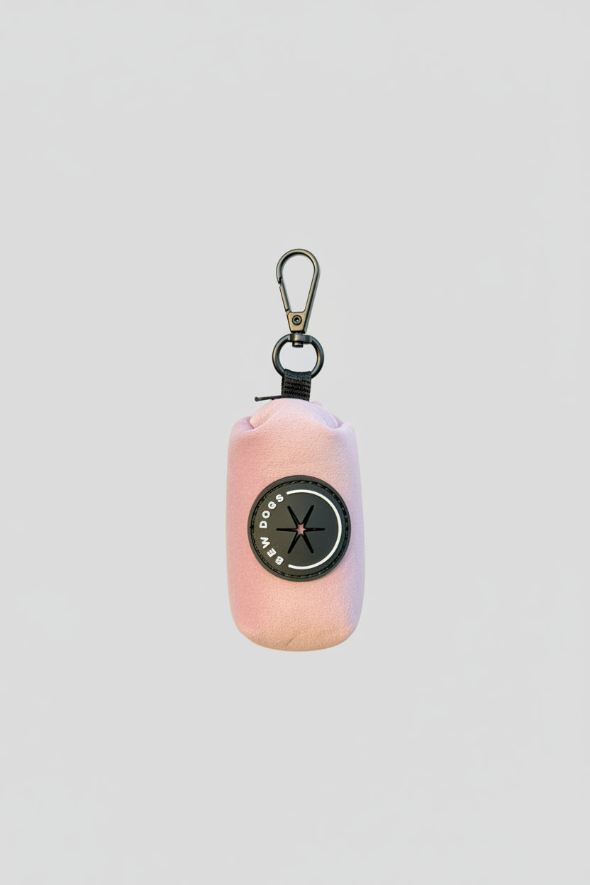 a rose pink velvet poo bag holder, shown in a studio against a white background
