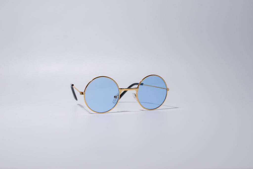 Round sunglasses with gold frame, novelty and fun item for cats or dogs, with blue lenses, sit against a light gray background
