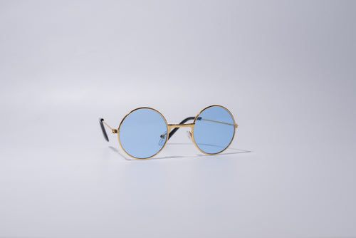 Round sunglasses with gold frame, novelty and fun item for cats or dogs, with blue lenses, sit against a light gray background