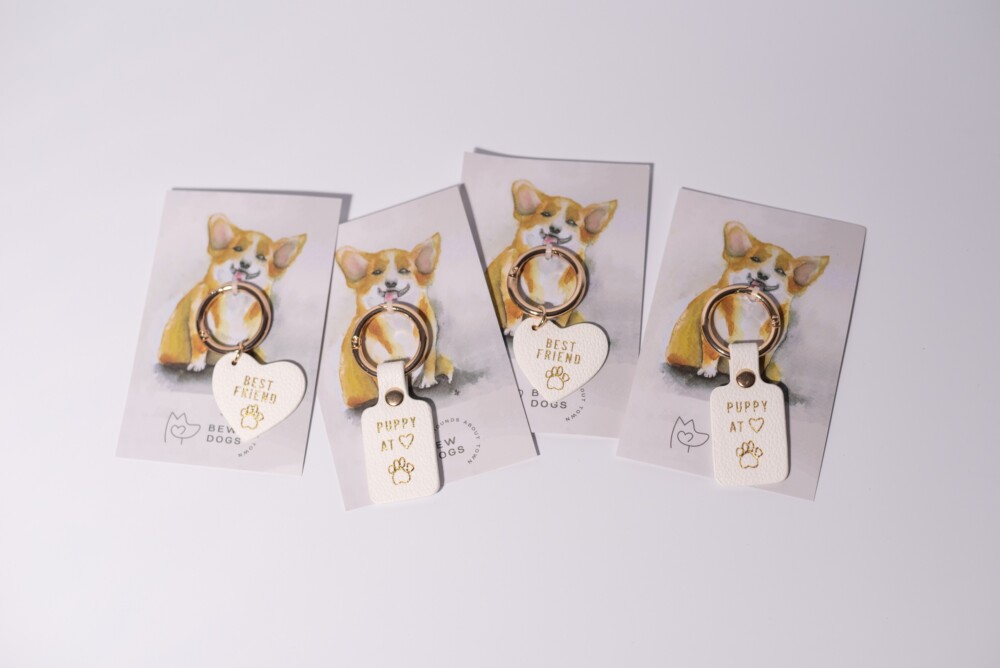 Four dog collar tags saying "best friend" or "puppy at heart" against a white background.