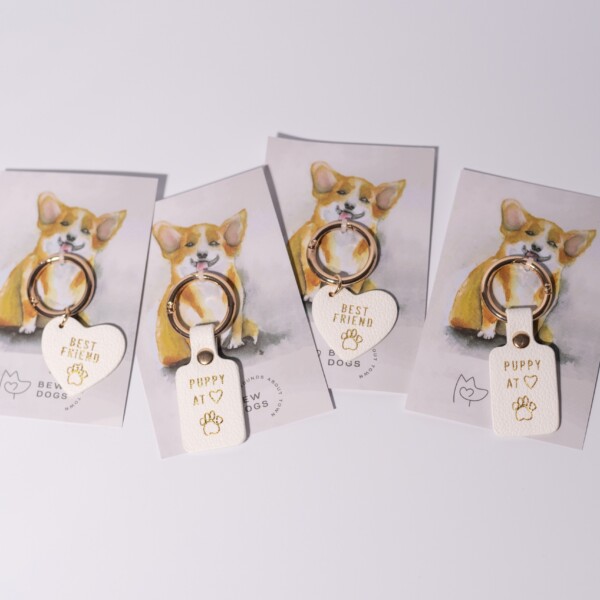 Four dog collar tags saying "best friend" or "puppy at heart" against a white background.
