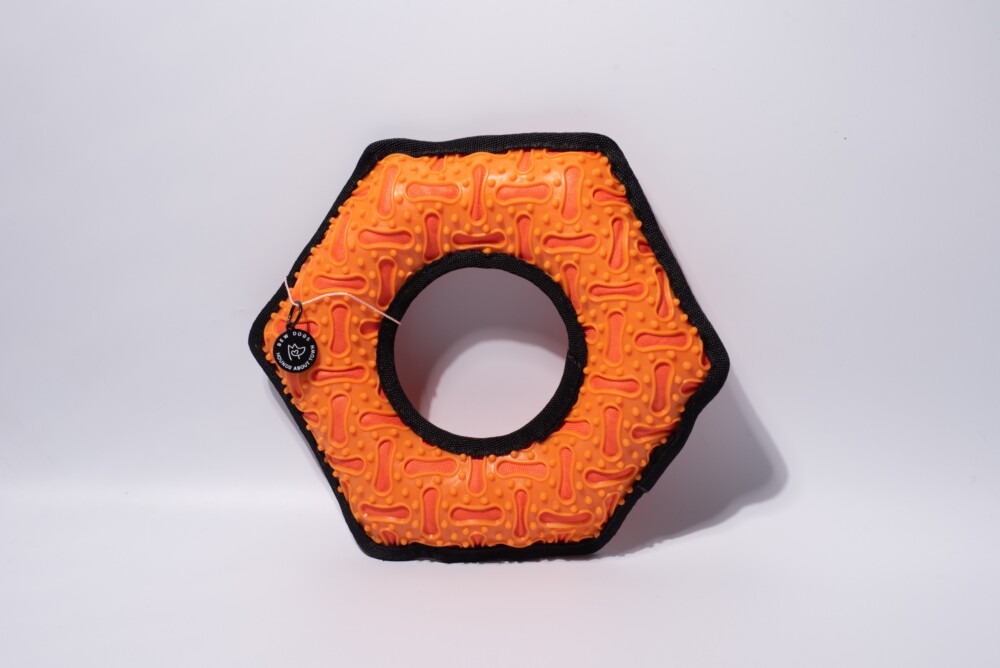 An orange hex durable dog toy against a white background