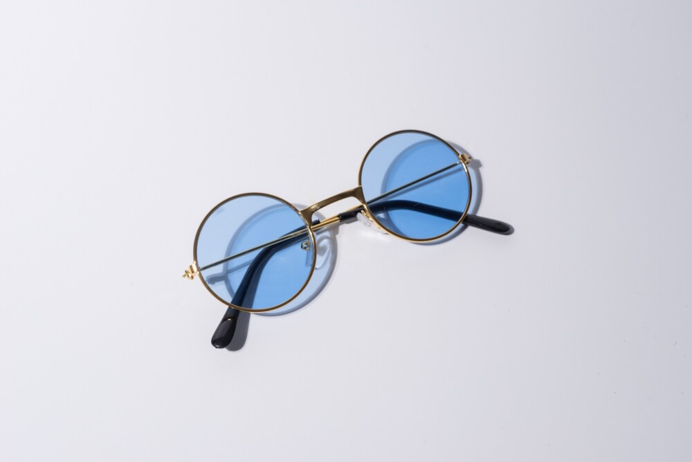 A pair of blue doggy specs on a white background.