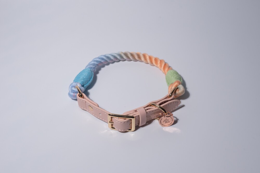 A blue and peach rope collar on a white background