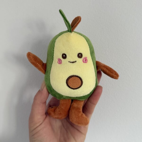 Adorable plush avocado dog toy, soft and cuddly, ideal for small dogs to play and cuddle with.